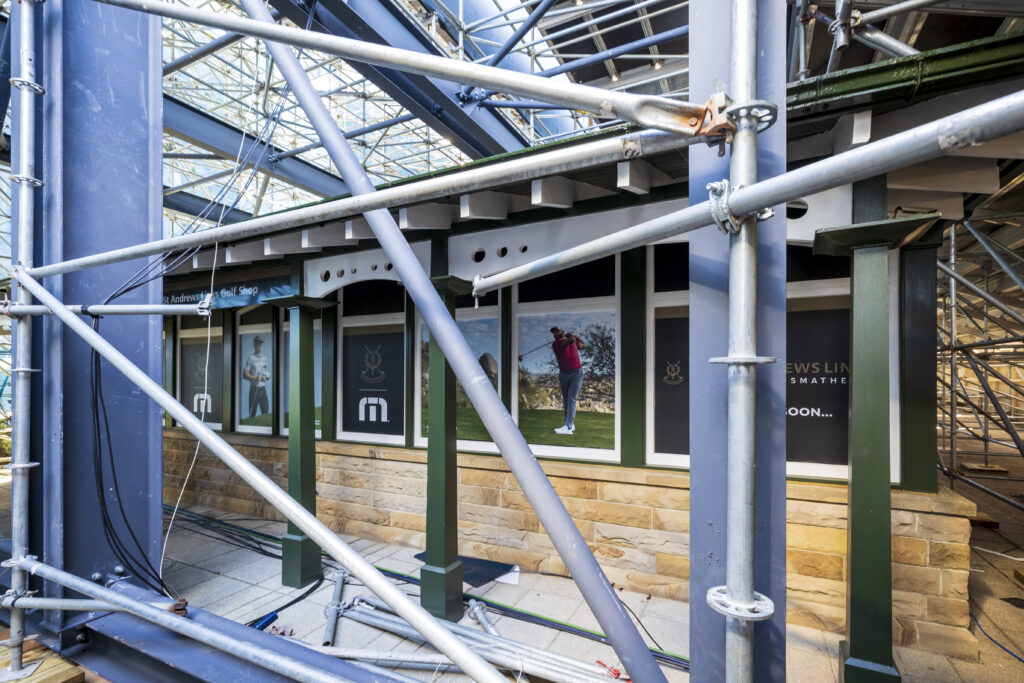 Temporary grandstand built around and over the top of the St Andrews Links Trust Shop., for the The Open St Andrews 150th 2022. Designed and delivered by GL events UK.